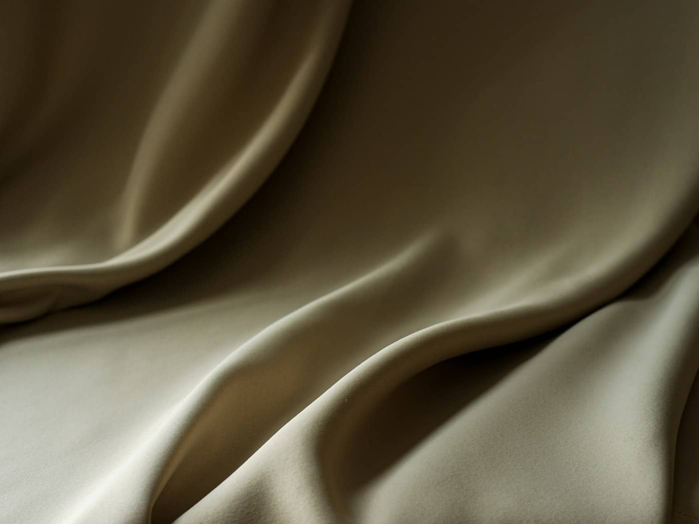 Warm champagne satin, softly draped in low light