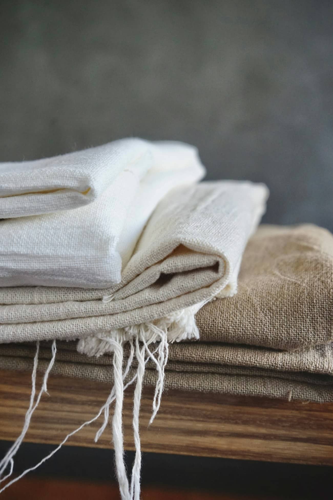 Stacked linen throws in warm natural light